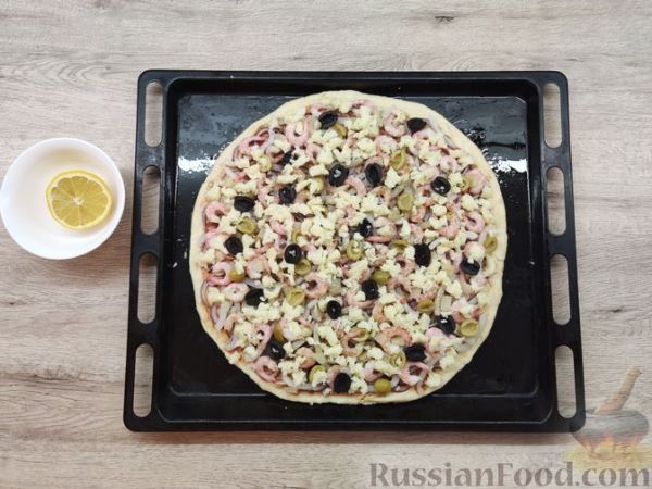 Пицца с морепродуктами, ананасом, маслинами и красным луком